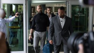 Tate brothers, facing human trafficking charges in Romania, arrive in the US