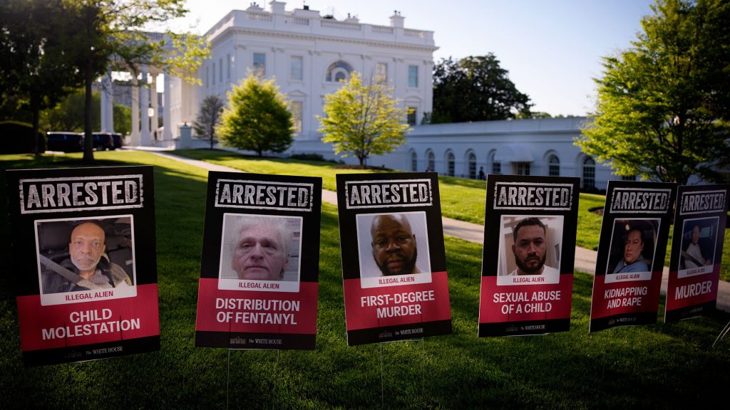 Migrant mugshots displayed along White House lawn