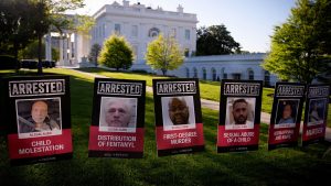 Migrant mugshots displayed along White House lawn