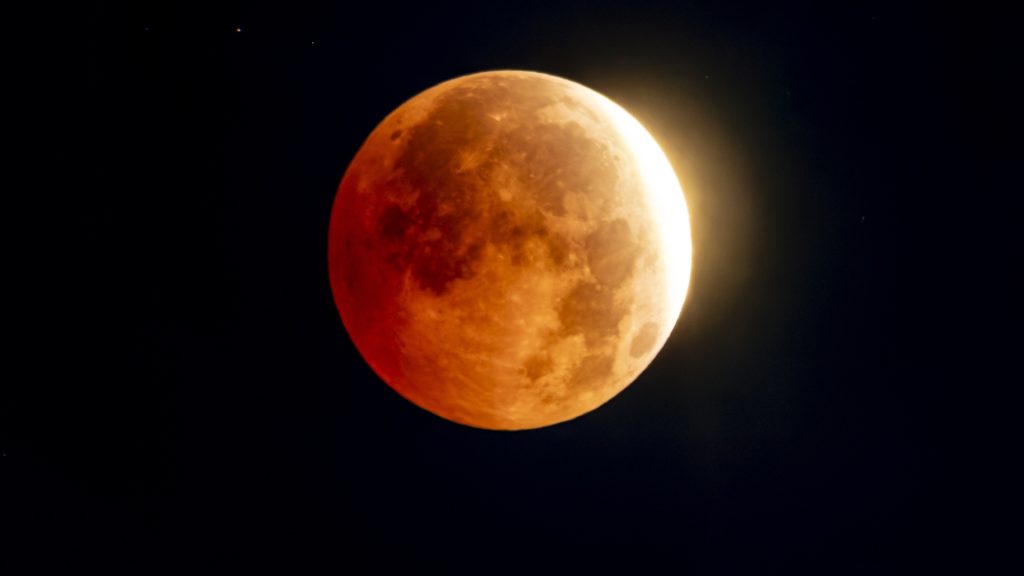Skywatchers get a dramatic look at a moon almost fully eclipsed